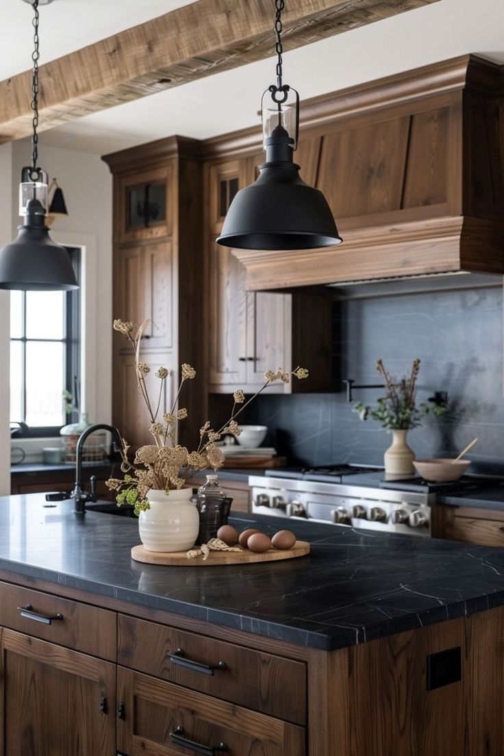 a large kitchen with wooden cabinets and black counter tops, along with an island in the middle