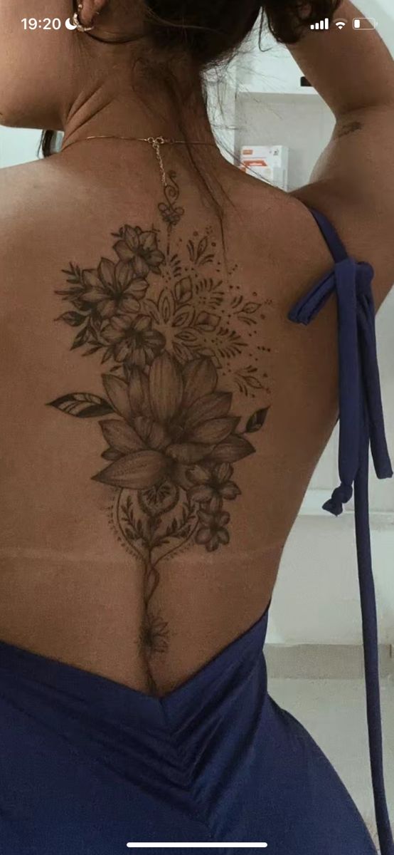 the back of a woman's body with flowers on it