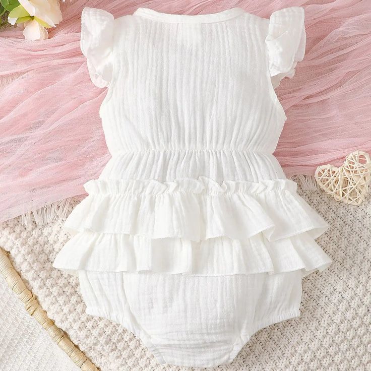 Introducing our Newborn Baby Girl White Halter Dress! Elevate your little one's summer wardrobe with our adorable halter dress designed for newborn baby girls. Made from soft and breathable cotton, this dress ensures comfort and style for your precious bundle of joy. Key Features: Comfortable Cotton Fabric: Crafted from high-quality cotton material, our halter dress is gentle on your baby's delicate skin, providing all-day comfort. Charming Design: The sleeveless, white button-down one-piece des Sweet Summer Beach Dresses, Cute Ruffled Bubble Romper For Vacation, Cute Bubble Romper With Ruffles For Vacation, Spring Cotton Bubble Romper For Playtime, Summer Bubble Romper With Ruffles For Beach, Solid Color Summer Baptism Dress, Cotton Bubble Romper With Short Sleeves For Spring, Spring Cotton Bubble Romper With Short Sleeves, White Ruffle Bubble Romper For Summer