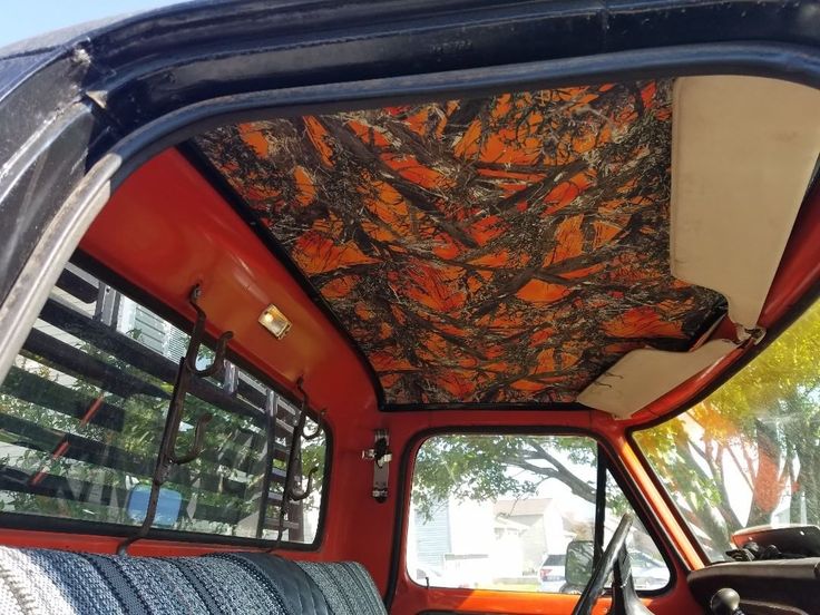 the interior of an old truck with orange and black paint on it's walls