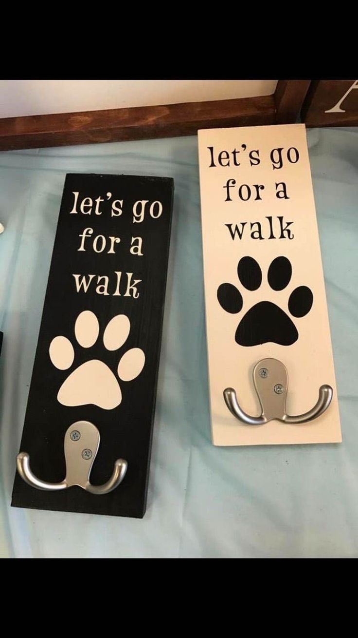 two door hangers that say let's go for a walk and dog paw