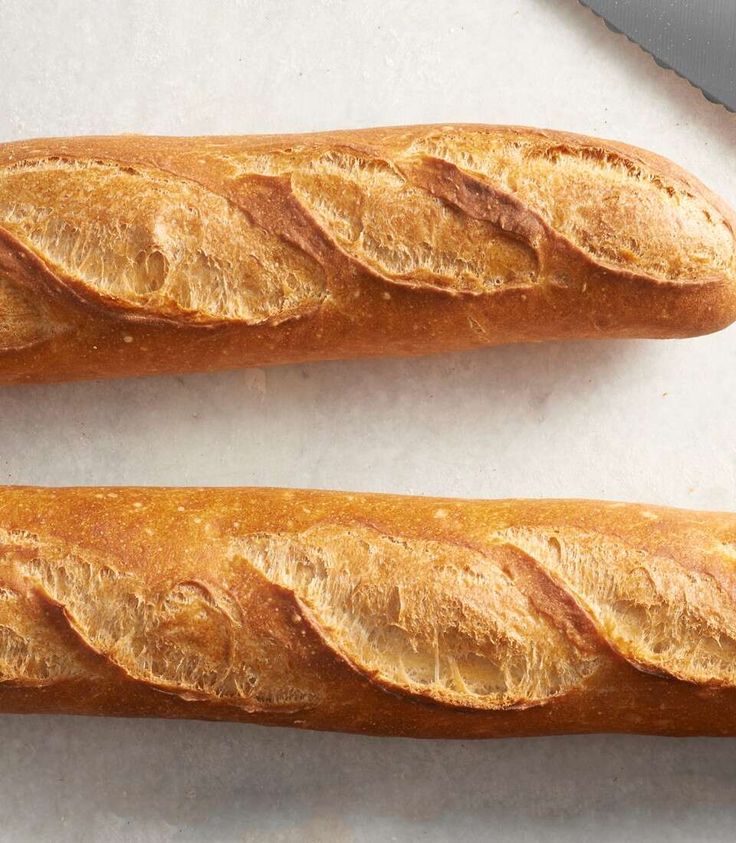 two long loafs of bread sitting next to each other