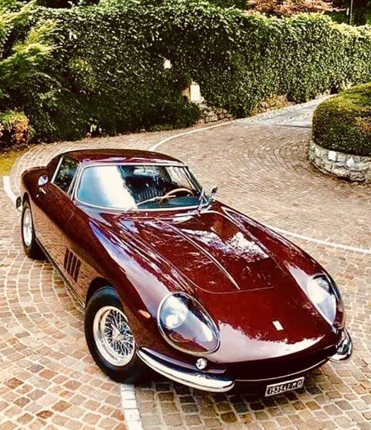 a red sports car is parked in the driveway