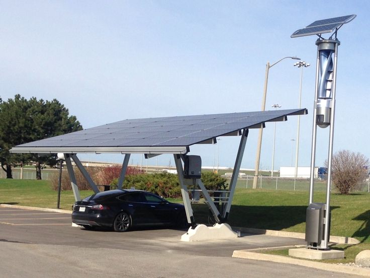 a car is parked under a solar panel