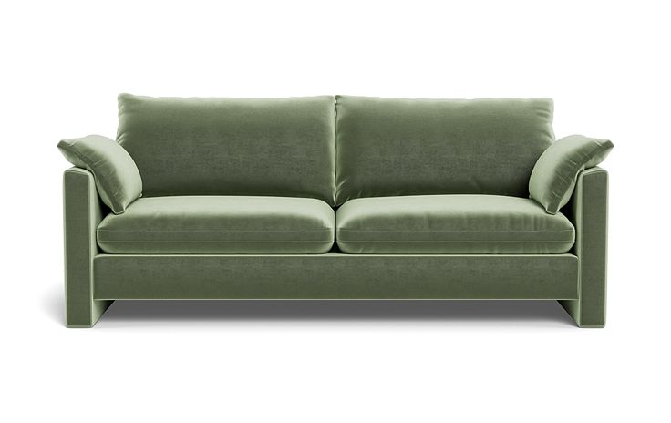 a green couch sitting on top of a white floor