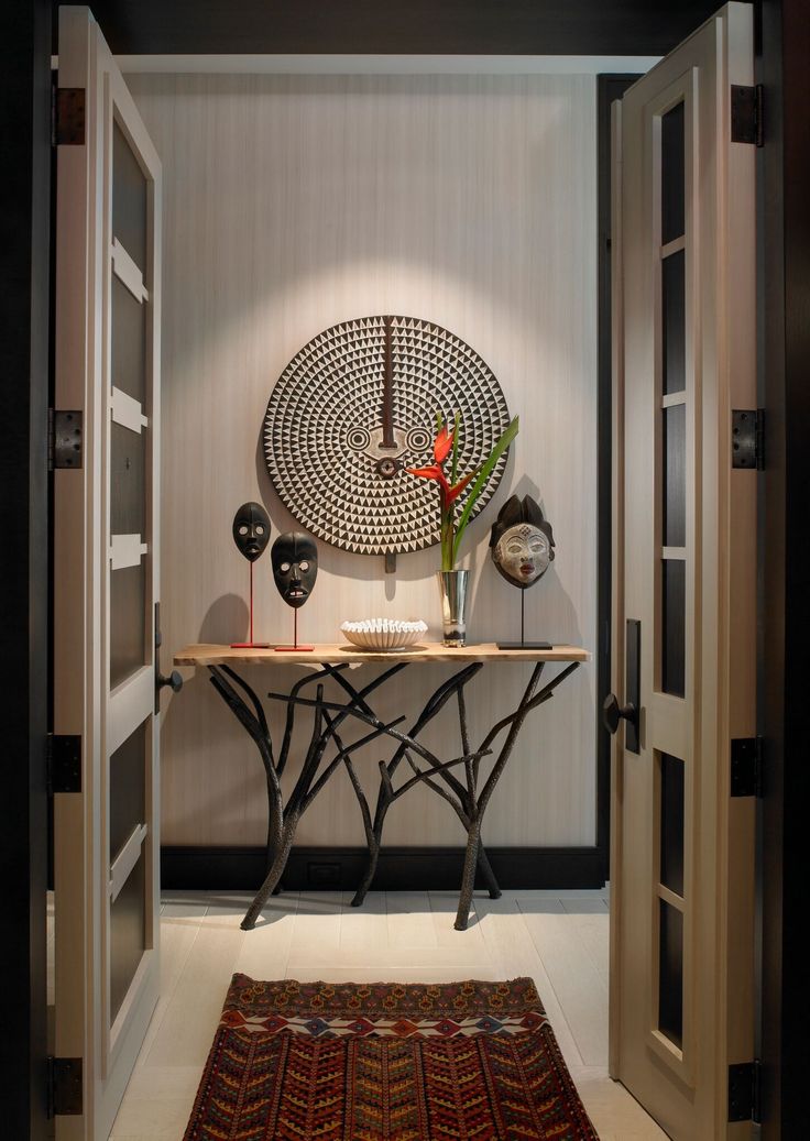 an entry way with a table and vases on it