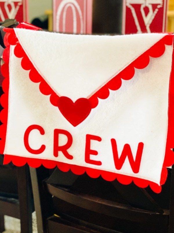 a red and white sign that says crew on it's side in front of some chairs