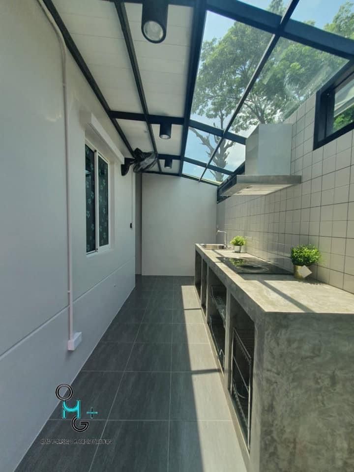 an outdoor kitchen area with tiled walls and flooring on the outside, along with skylights