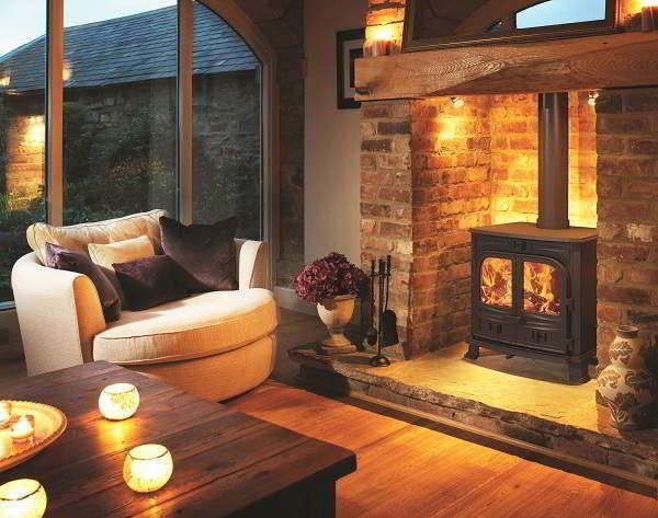 a living room filled with furniture and a fire place in front of a large window