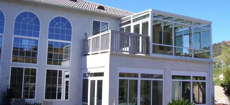 a large white house with many windows and balconies