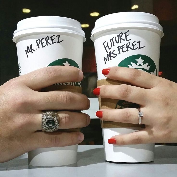 two women holding coffee cups with their hands