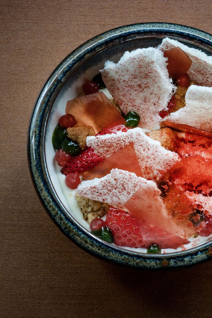 a bowl filled with fruit and powdered sugar