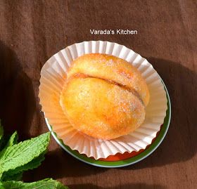 two pastries sitting on top of a paper plate next to mints and leaves