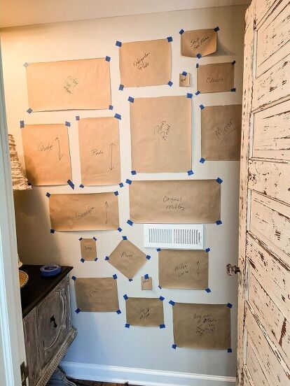 several pieces of paper are taped to the wall with blue tape and pinned on them