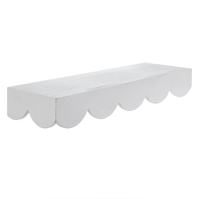 a white shelf with scalloped edges against a white background