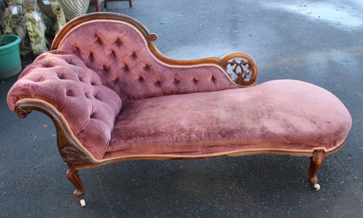 an old pink velvet chaise lounge chair