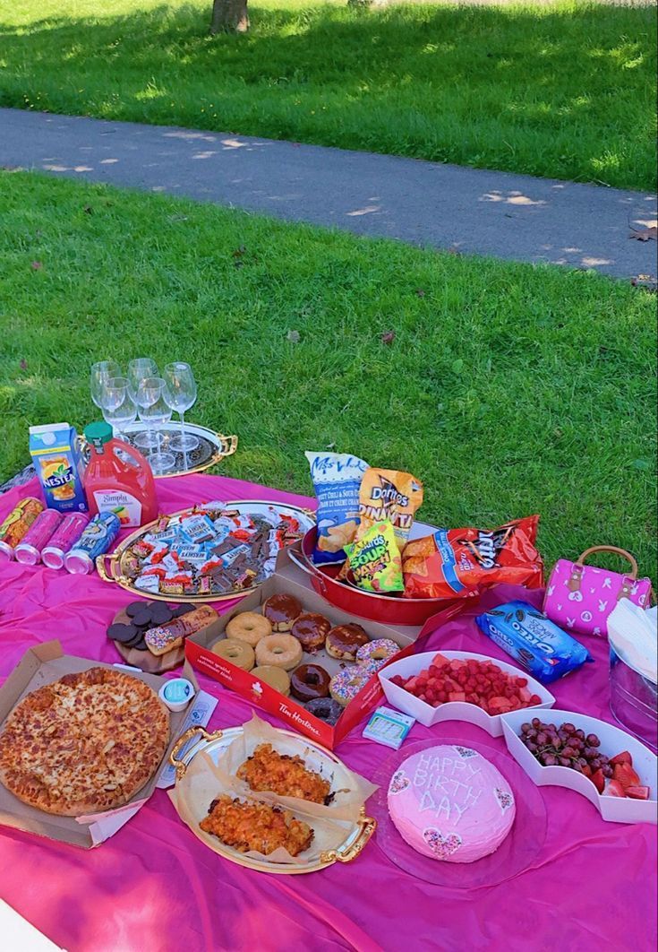 a picnic table with food and snacks on it