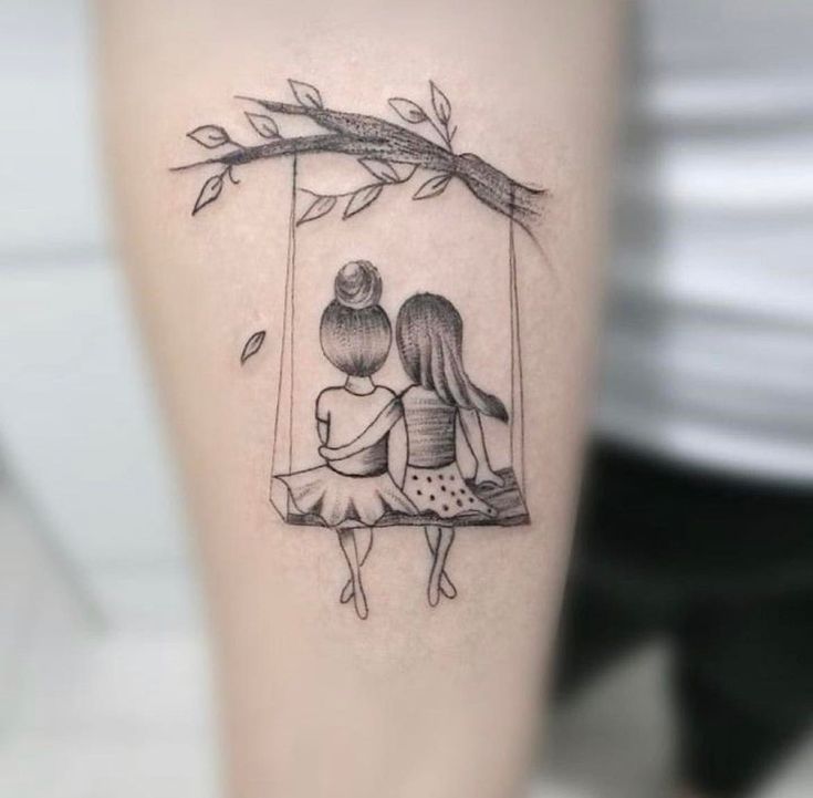 a couple is sitting on a swing tattoo by the tree branch and holding each other's hands