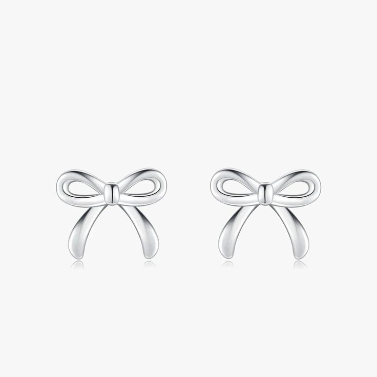 Discover the epitome of sweetness and style with our Charming Bowknot Hypoallergenic Stud Earrings. Perfectly capturing the essence of simplicity and elegance, these cute stud earrings feature an exquisite bowknot design that adds a touch of whimsy to any look. Crafted with care, these earrings are made from hypoallergenic materials, ensuring they're gentle on even the most sensitive ears. Each bowknot is meticulously designed to showcase a blend of classic charm and modern sophistication, making these earrings a versatile addition to any jewelry collection. Whether you're dressing up for a special occasion or adding a playful touch to your everyday ensemble, these bowknot studs are sure to become your go-to accessory. Not only do these earrings boast a timeless design, but they also prior White Gold Bow Earrings For Gift, Classic Bow Earrings For Anniversary, Dainty Silver Bow Earrings, Elegant Butterfly Knot Earrings As Gift, Elegant Butterfly Knot Earrings For Gift, Classic Bow Earrings For Party, Bow Earrings For Gift, Chic Silver Earrings With Decorative Bow, Chic Butterfly Knot Earrings As Gift