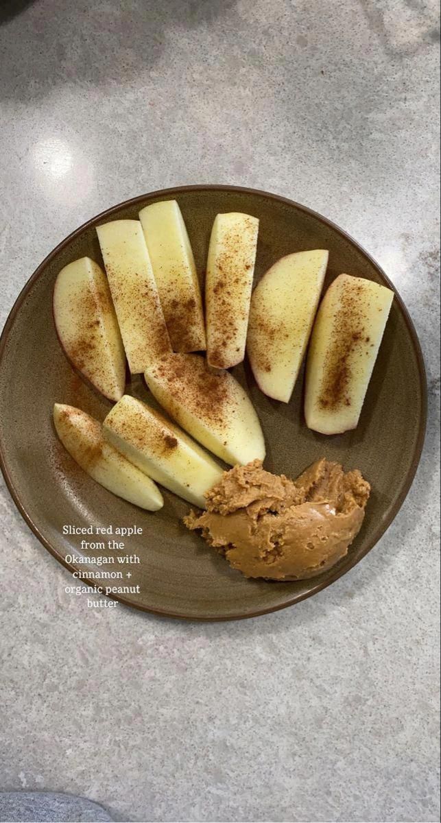 sliced apples and peanut butter on a plate