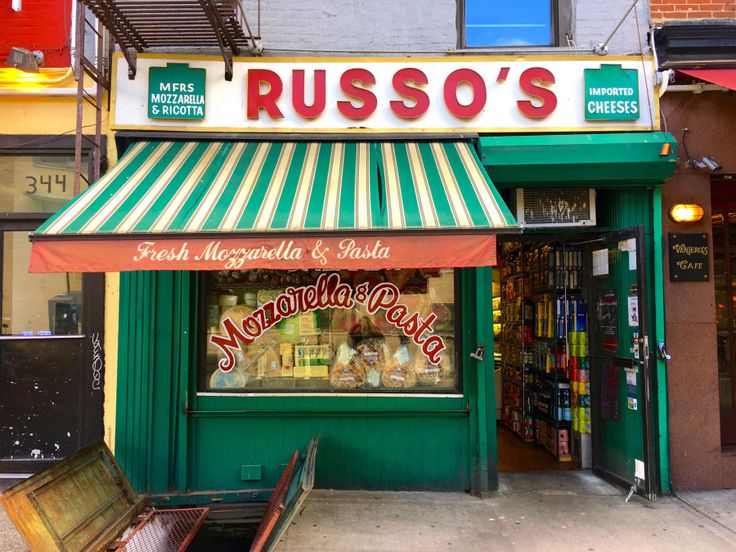 a green and white striped awning over a store front