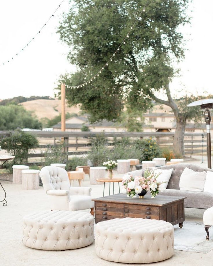 an outdoor seating area with couches, chairs and tables in the middle of it