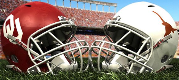 two football helmets sitting on top of a lush green field