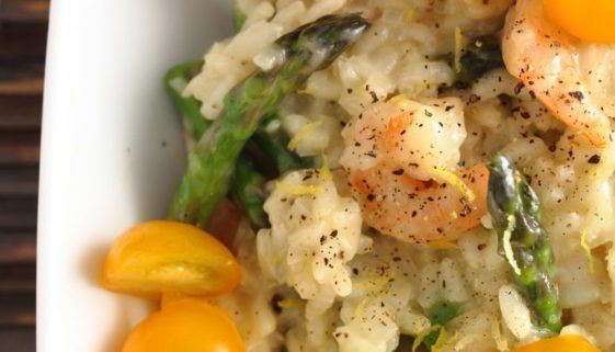 shrimp and rice with asparagus in a white bowl