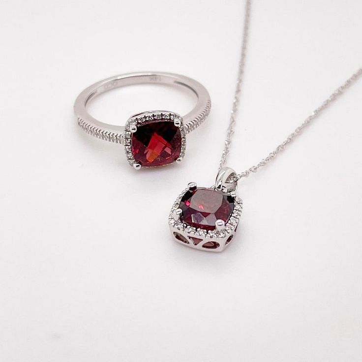 This deep red cushion-cut garnet is breathtaking and set beautifully within a diamond halo. This necklace was designed with a matching ring as shown in the pictures. These two make a stunning set that is the perfect addition to any jewelry collection. The necklace looks great on any woman as it will match their lipstick and lips! The details for this beautiful necklace are listed below:Metal Quality: 14K White GoldPendant Style: Garnet Diamond HaloDiamond Number: 20Diamond Shape: Round Brilliant Luxury Red Jewelry With Gemstone Accents, Luxury Ruby Jewelry With Halo Design, Formal Jewelry With Halo Design, Exquisite Ruby Jewelry With Halo Setting, Elegant Ruby Jewelry With Halo Setting, Cushion Cut Ruby Jewelry As Gift, Cushion Cut Ruby Jewelry For Gift, Cushion Cut Ruby Jewelry Gift, Timeless Garnet Jewelry For Anniversary