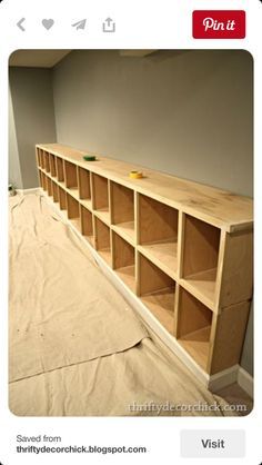 an empty room with some shelves on the floor