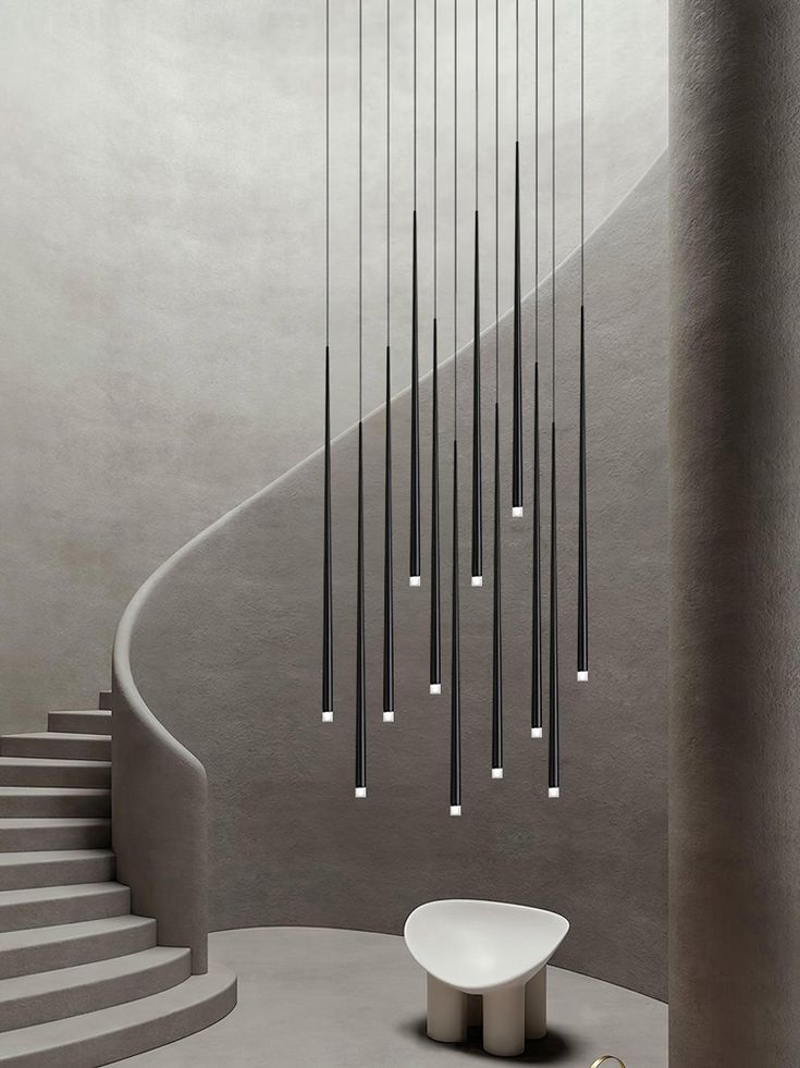 a room that has some lights hanging from the ceiling and stairs in front of it