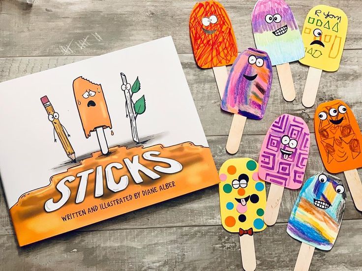 popsicles made out of paper are sitting on a table next to an activity book