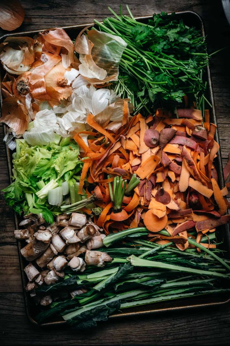 an assortment of vegetables are laid out on a tray