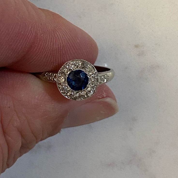 Ladies 14 K White Gold Sapphire Ring With One Medium Blue Color, Gia Type 11 Clarity, Vs2 Round Faceted Cut Sapphire. The Sapphire Weights .32 Carat, Measure 4.1 Mm Wide By 4.1 Mm Long And Is Bezel Set In 14 K White Gold. In Approximate Weight Of .10 Carat. Appraisal Is $950 Size 8 Diamond White Sapphire Ring In Platinum As Gift, Blue Diamond Cluster Ring With Gemstone, Blue Sapphire Heirloom Ring With Halo Design, Blue Diamond Ring With Center Stone, Heirloom Blue Sapphire Ring With Diamonds, Classic Blue Halo Ring For Formal Occasions, Diamond White Platinum Sapphire Ring Gift, Blue Diamond Ring With Center Stone In Round Band, Blue Topaz Cluster Ring For Anniversary