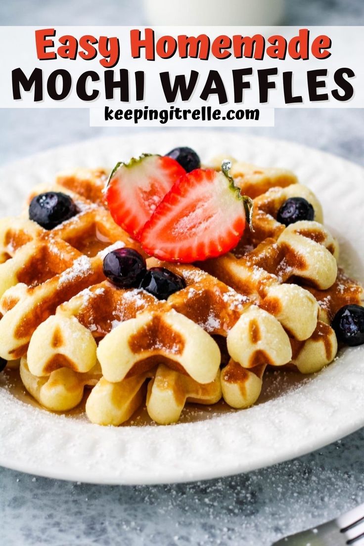 a plate with waffles and strawberries on it