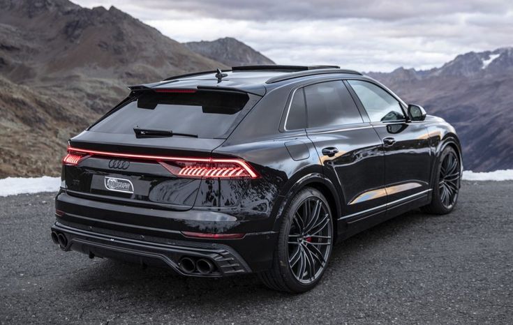 an audi suv parked on the side of a mountain road