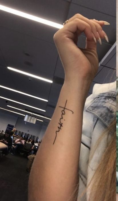 a woman's arm with the word faith tattooed on her left wrist and an image of a cross