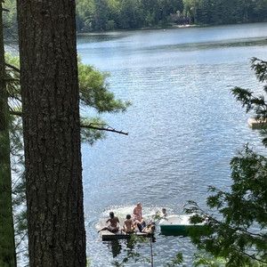 some people are sitting on a small boat in the middle of a body of water