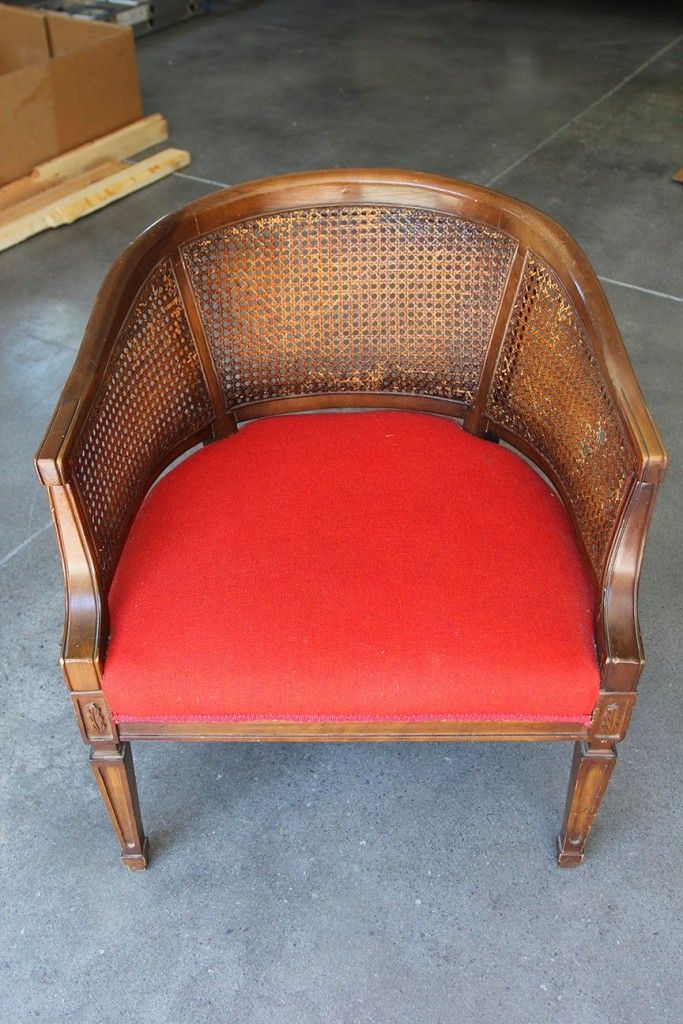 a red chair sitting on top of a cement floor