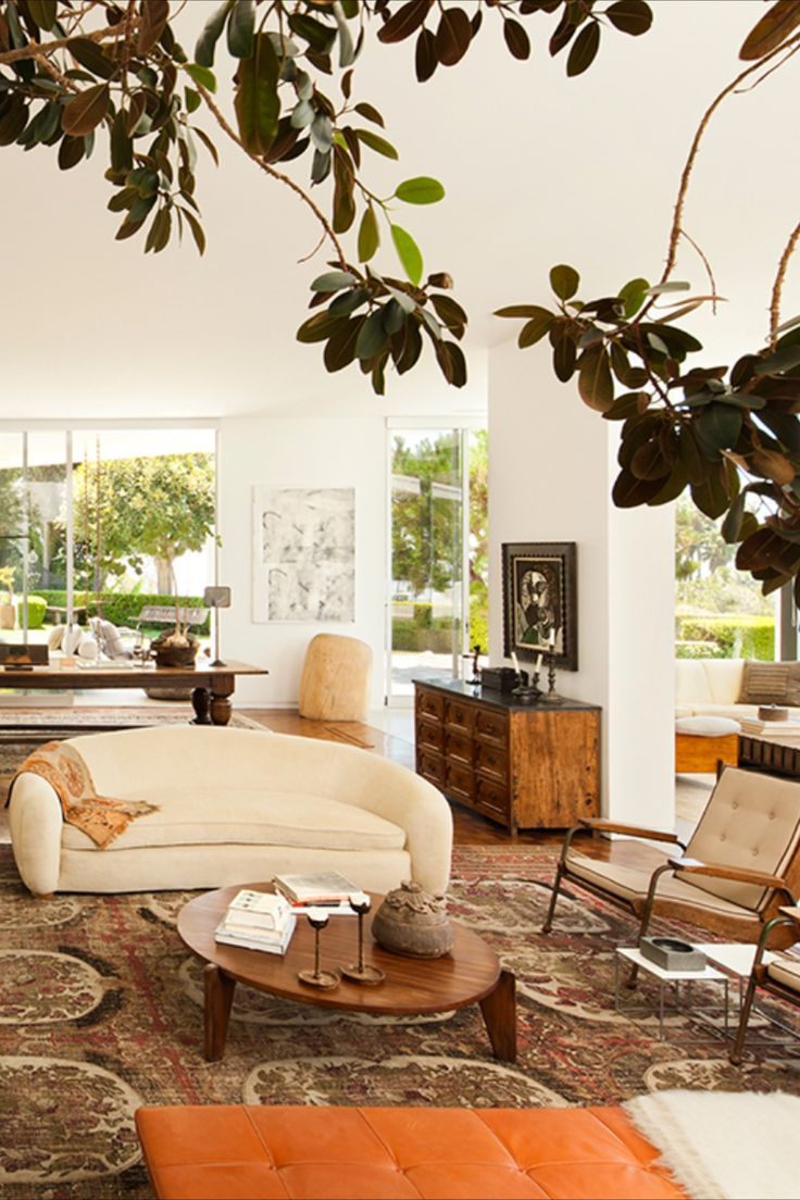 a living room filled with furniture and lots of windows