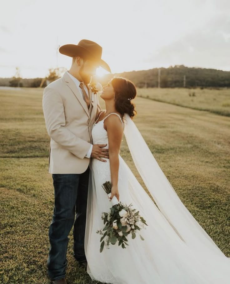 a bride and groom kissing in the sun