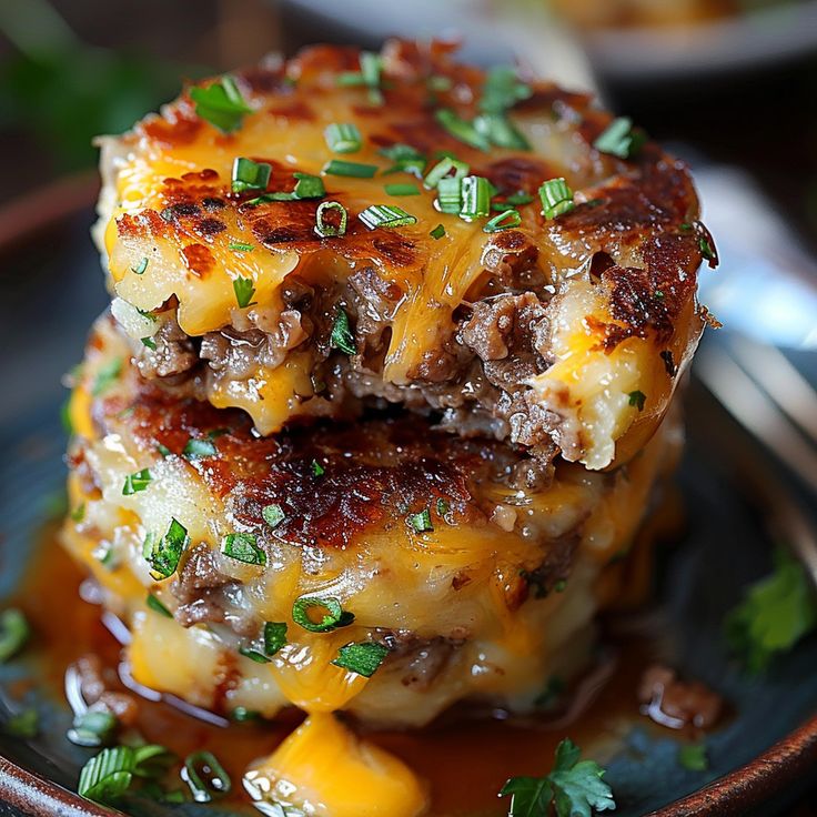 two cheeseburger patties stacked on top of each other