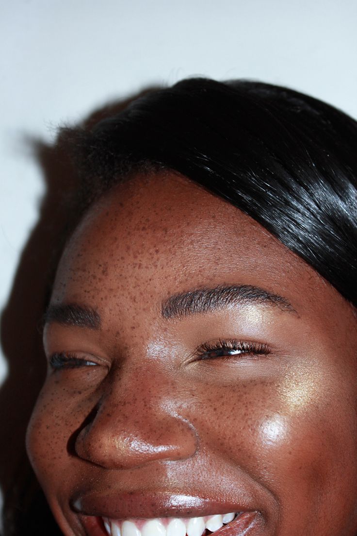 a woman with freckled hair smiling at the camera