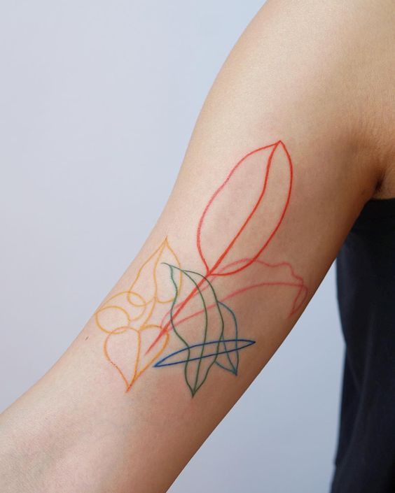 a woman with a tattoo on her arm that is colored red, yellow and blue