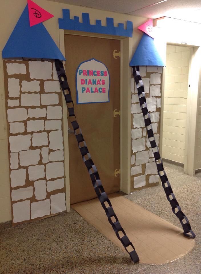 a cardboard castle door with two ladders leading to it and a princess tiara's palace sign on the door