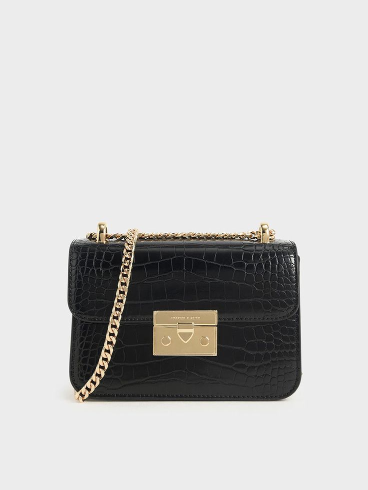 Thanks to its classic cut, this black mock-croc crossbody bag with a chain handle strap will be one you'll look forward to bringing everywhere. Plus, the push-lock closure promises ease of use. Team it with anything from pantsuits to flowy dresses. Black Joggers Outfit, Charles And Keith, Leather Joggers, Joggers Outfit, Chain Strap Bag, Charles Keith, Black Joggers, Bag Trends, Black Chain