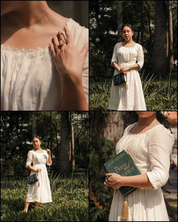 the woman is wearing a white dress and holding a book in her hands while standing outside