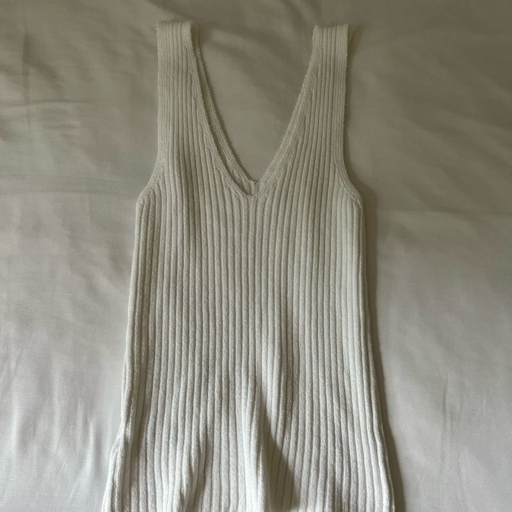 Brandy Melville Knit Top Never Worn, Excellent Condition No Tags Perfect For The Summer White Open Knit Sweater Vest, Cozy Knit Top For Day Out, White Textured Knit V-neck Sweater Vest, Summer V-neck Ribbed Sweater, White Sleeveless Pointelle Knit Sweater, White Stretch Knit Top For Loungewear, Soft Knit V-neck Top For Day Out, V-neck Pointelle Knit Sweater Vest, Casual White Open Knit Sweater Vest