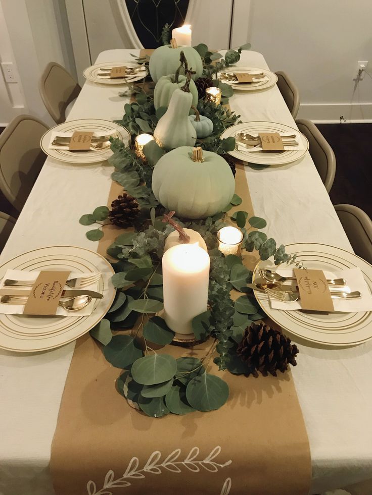 the table is set with candles, plates and napkins for dinner guests to enjoy