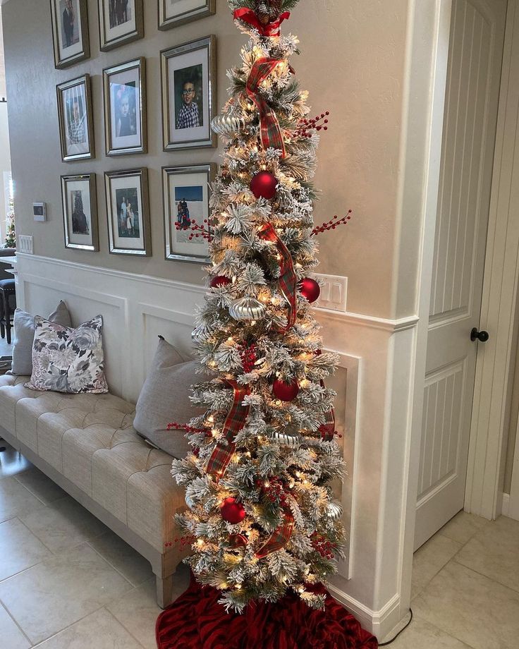 a white christmas tree with red and silver ornaments